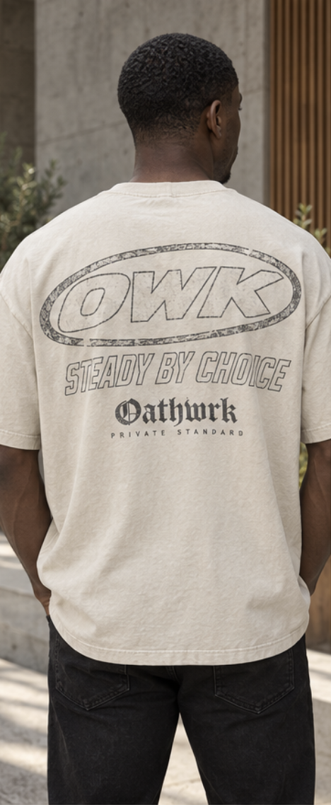 Bone tee with the outlined OWK oval and Steady by Choice lettering