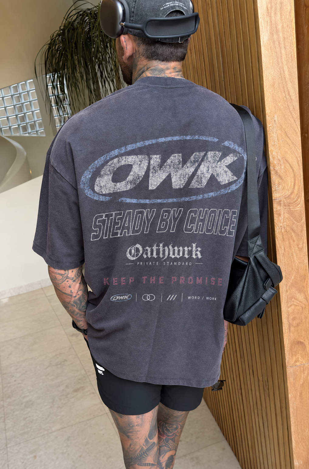 The original OATHWRK Steady by Choice graphic on a washed charcoal tee, worn in an everyday setting